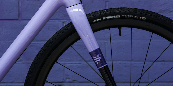 Fork detail, shot from the side, on an Ibis Hakka MX bicycle in Wizard Potion Purple