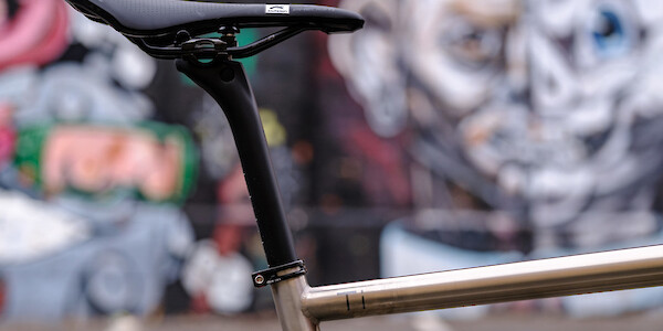 Detail of a saddle and Bossi carbon post on a Bossi Strada titanium road bike frame