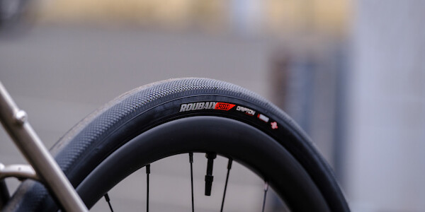 Detail of a rear hand-built carbon bicycle wheel, fitted to a Bossi Summit titanium frameset