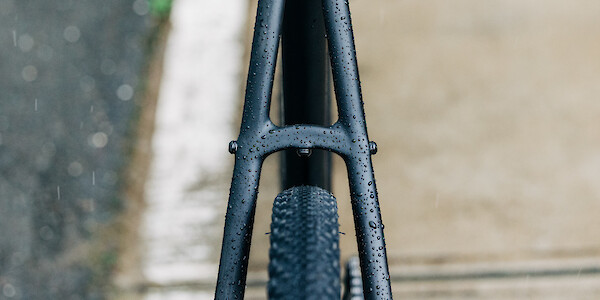 Rear tyre and frame detail on a Fuji Jari 1.3 Carbon bicycle, rain droplets clinging to the frame