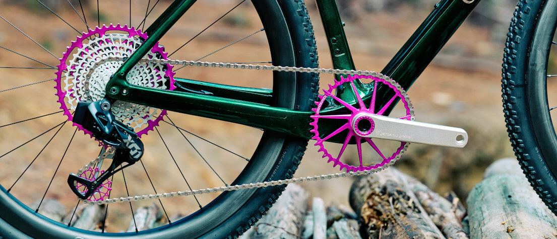 Drivetrain detail of Garbaruk bicycle components in violet, fitted to a carbon gravel bike