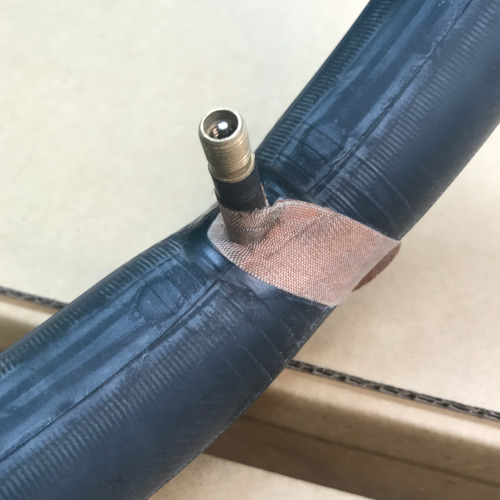 A bicycle tube which someone has attempted to fix with a bandaid. (Spoiler alert: it didn't work.)