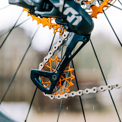 Orange Garbaruk jockey wheels fitted to a derailleur