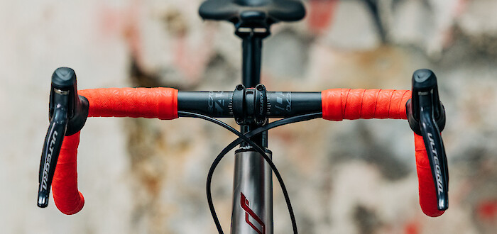 Front view of a Bossi Strada titanium bike, showing the red hand-painted logo on the frame