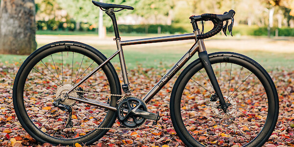 Bossi Strada titanium road bike against a backdrop of autumn leaves