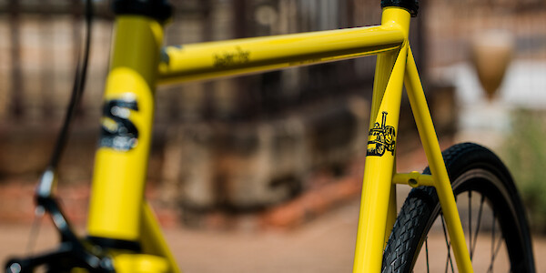 Surly Steamroller bicycle in Banana Candy yellow, frame and steamroller decal detail