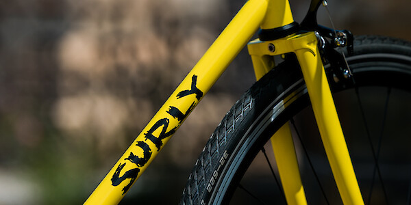 Frame decal detail on a Banana Candy yellow Surly Steamroller steel bike