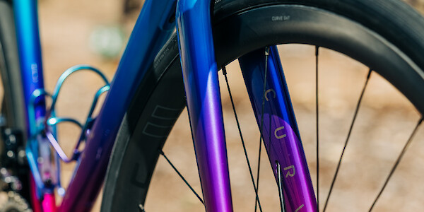 Detail on a blue, pink and purple custom-painted Curve bicycle fork