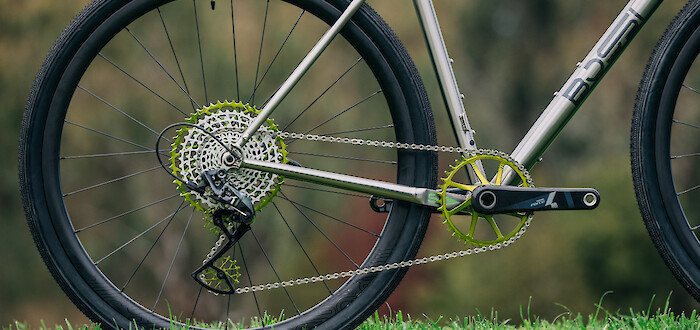Drivetrain detail on a Bossi Grit SX titanium gravel bike, with green Garbaruk components visible