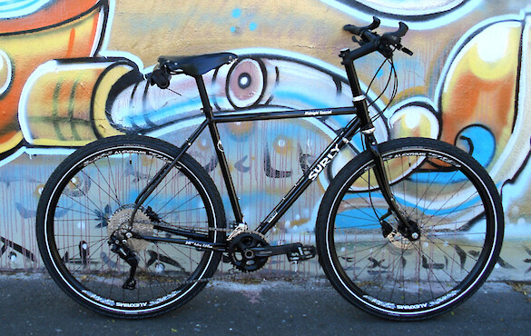 Surly Midnight Special bicycle in a custom build, against a wall of street art