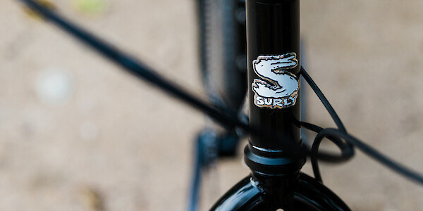 Headtube badge detail on a black Surly Bridge Club bicycle