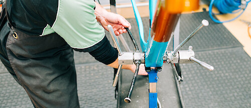 A carbon bicycle frame being professionally faced at Bio-Mechanics Cycles & Repairs' workshop by Pete, BMCR's head mechanic