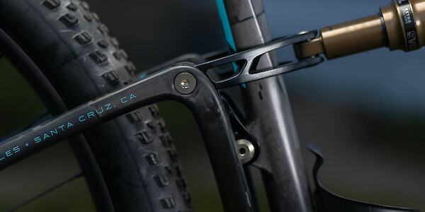 Rear shock linkage detail on an Ibis Exie carbon mountain bike in Bug Zapper Blue
