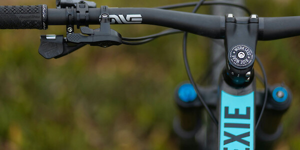 Top-tube decal detail on a Ibis Exie carbon mountain bike in Bug Zapper Blue, viewed from above