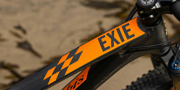 Top-tube decal detail on a Ibis Exie carbon mountain bike in Cheat-O Orange