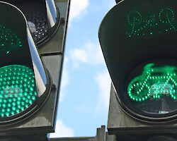 A green traffic light, also displaying a green bicycle light
