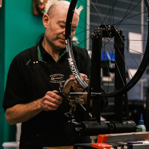 A professional bicycle mechanic, working on a wheel at Bio-Mechanics Cycles & Repairs