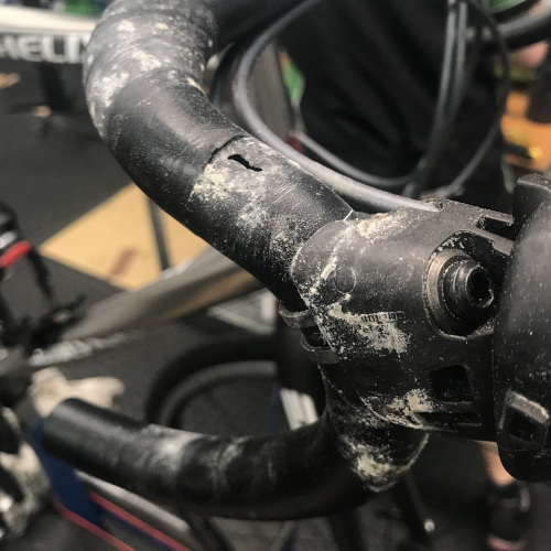 Close-up of a set of alloy bicycle handlebars with a hole in them from sweat-related corrosion.