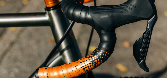 Orange and black Ciclovation handlebar tape, fitted to a custom-built Bossi Grit SX titanium gravel bike