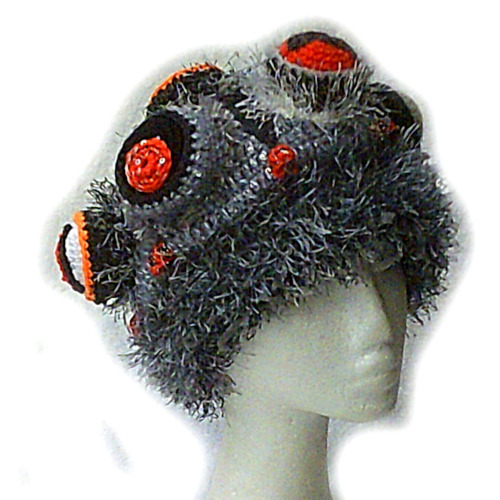 Magpie-deterring hat, which looks like a beanie covered in red blobs.