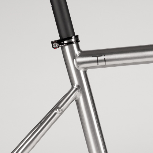 Frame detail on a titanium Bossi bicycle, close-up on the seat tube/seat stay junction
