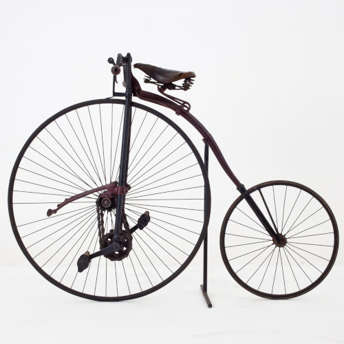 A penny farthing, shot from the side against a white background