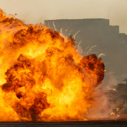 An exploding fireball in an industrial setting.