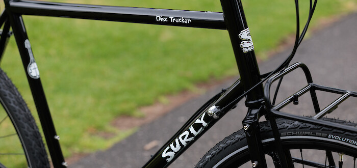 Decal details on a custom-built black Surly Disc Trucker steel touring bike.
