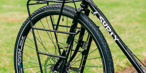 A Surly Nice front rack fitted to a custom-built black Surly Disc Trucker steel touring bike.