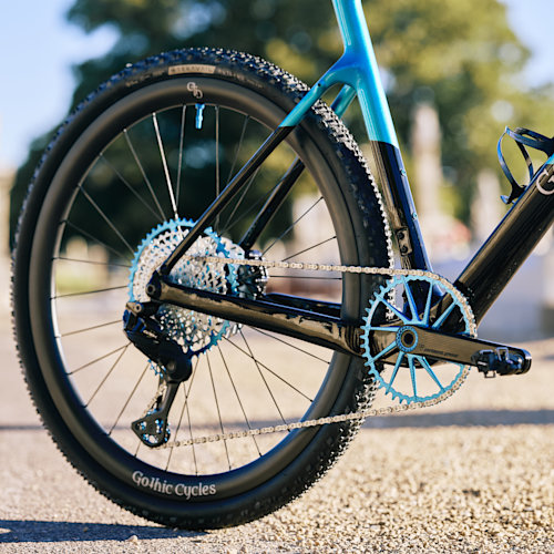 Drivetrain detail of blue Garbaruk gear components, fitted to a carbon Gothic Cycles gravel bike