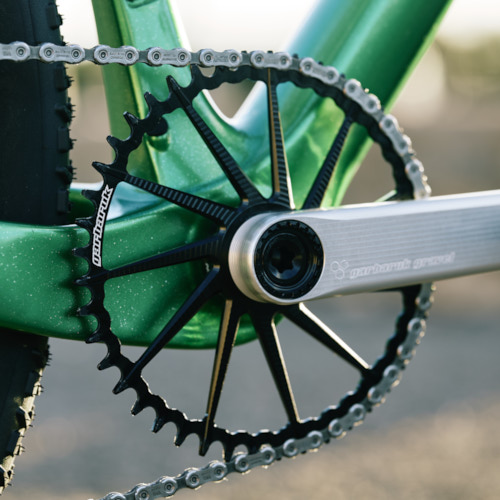 Drivetrain detail of an black Garbaruk chain ring, fitted to a carbon Gothic Cycles gravel bike