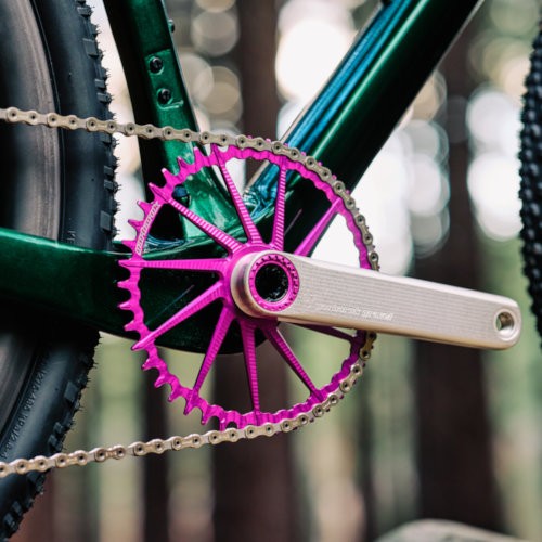 Drivetrain detail of a violet Garbaruk chain ring, fitted to a carbon Gothic Cycles gravel bike