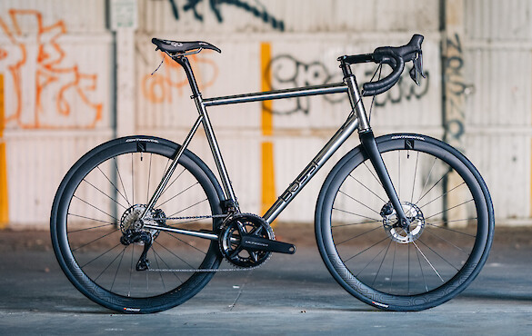 Bossi Strada Classic titanium road bike in a custom build by BMCR, shot in a warehouse with graffiti in the background