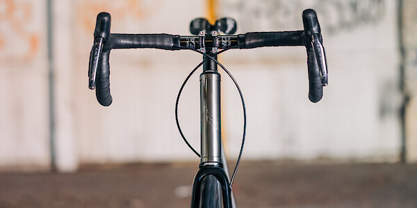 A custom-built Bossi Strada Classic titanium road bike, shot from the front at eye level