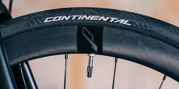 A Bossi bicycles carbon rim with a Continental tyre fitted to it.