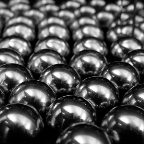 Close-up of many silver balls, light reflecting off them.