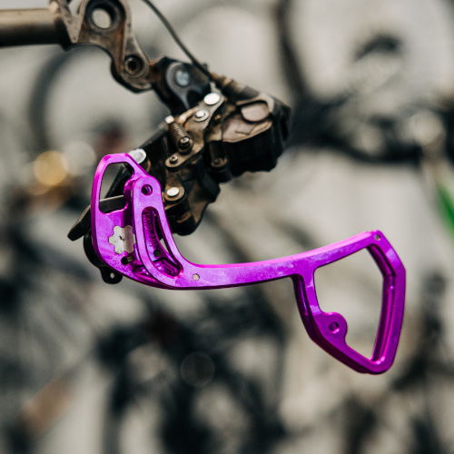 A purple rear derailleur cage by Garbaruk bicycle components