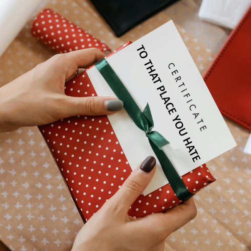 A woman's hands, holding a gift certificate.
