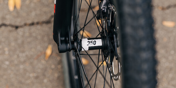 DT Swiss hub detail on the front wheel of an Esker Hayduke touring mountain bike, custom-built by Bio-Mechanics Cycles & Repairs.