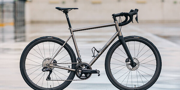 Custom-built Bossi Summit titanium road bicycle, photographed on a roof carpark on a wet and moody day