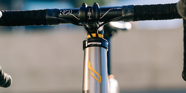 Gold air-brushed detailing on a titanium Bossi Summit endurance bike, custom-made by Bio-Mechanics Cycles & Repairs