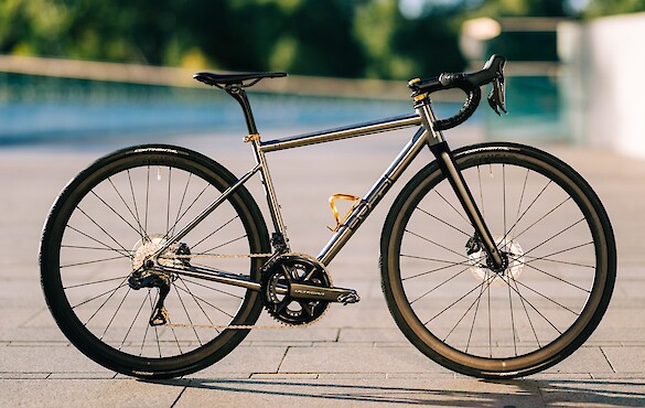 Bossi Summit titanium endurance bike, custom-built by Bio-Mechanics Cycles & Repairs, gold components gleaming in the sun