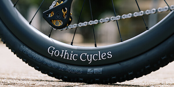 Close-up detail on a Gothic Cycles hand-built wheel and gold Garbaruk jockey wheels