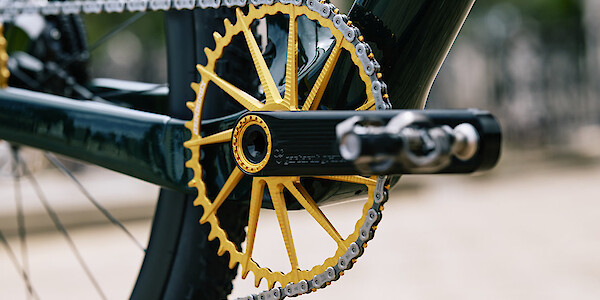 Close-up on a gold Garbaruk chainring, fitted to a custom-built Gothic Cycles Aix carbon gravel bicycle