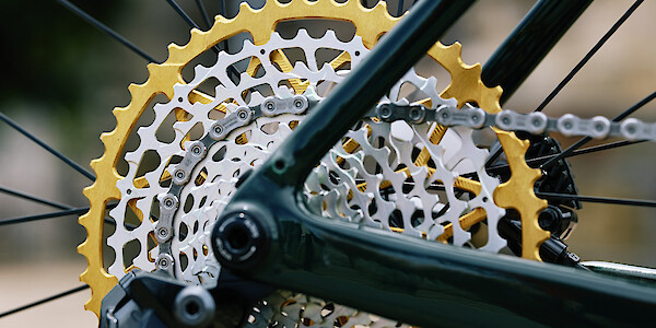 Close-up detail of a gold Garbaruk cassette, fitted to a custom-built Gothic Cycles Aix carbon gravel bicycle