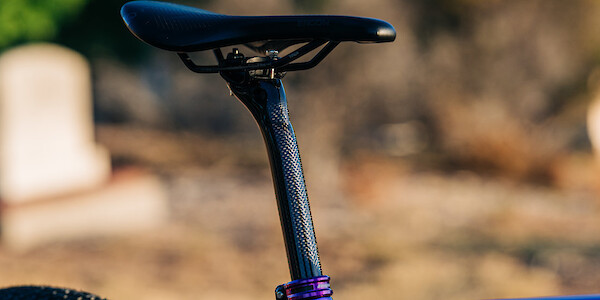 Ergon SR Pro saddle with purple Hope seat clamp on Gothic Aix carbon gravel bike