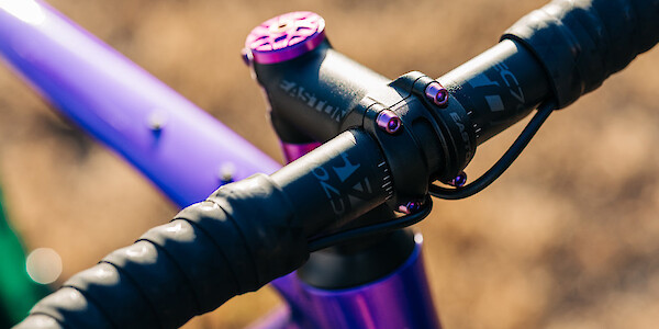 Purple Hope headset spacers, purple Garbaruk top cap and purple titanium bolts on Gothic Aix custom-built carbon gravel bike