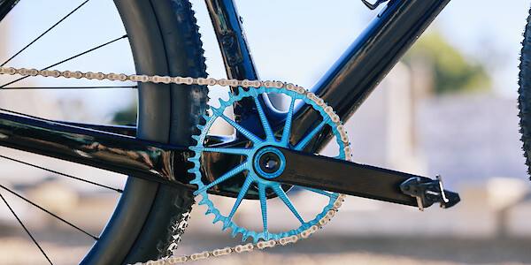Blue Garbaruk chainring fitted to a carbon Gothic Cycles gravel bike.