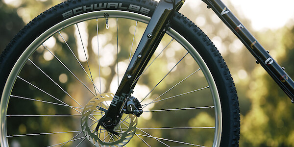 Carbon fork on a custom-built Veloci Roadmance steel gravel bicycle, photographed in a garden