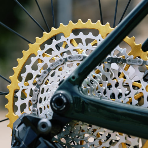 Drivetrain detail of a gold Garbaruk cassette, fitted to a carbon Gothic Cycles gravel bike